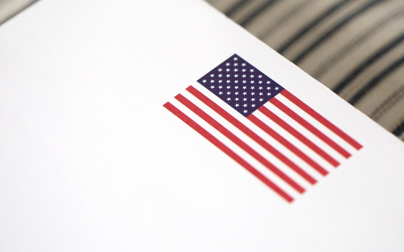 A photograph of the Flag Notepad. It has a picture of the flag centered at the top on white paper.