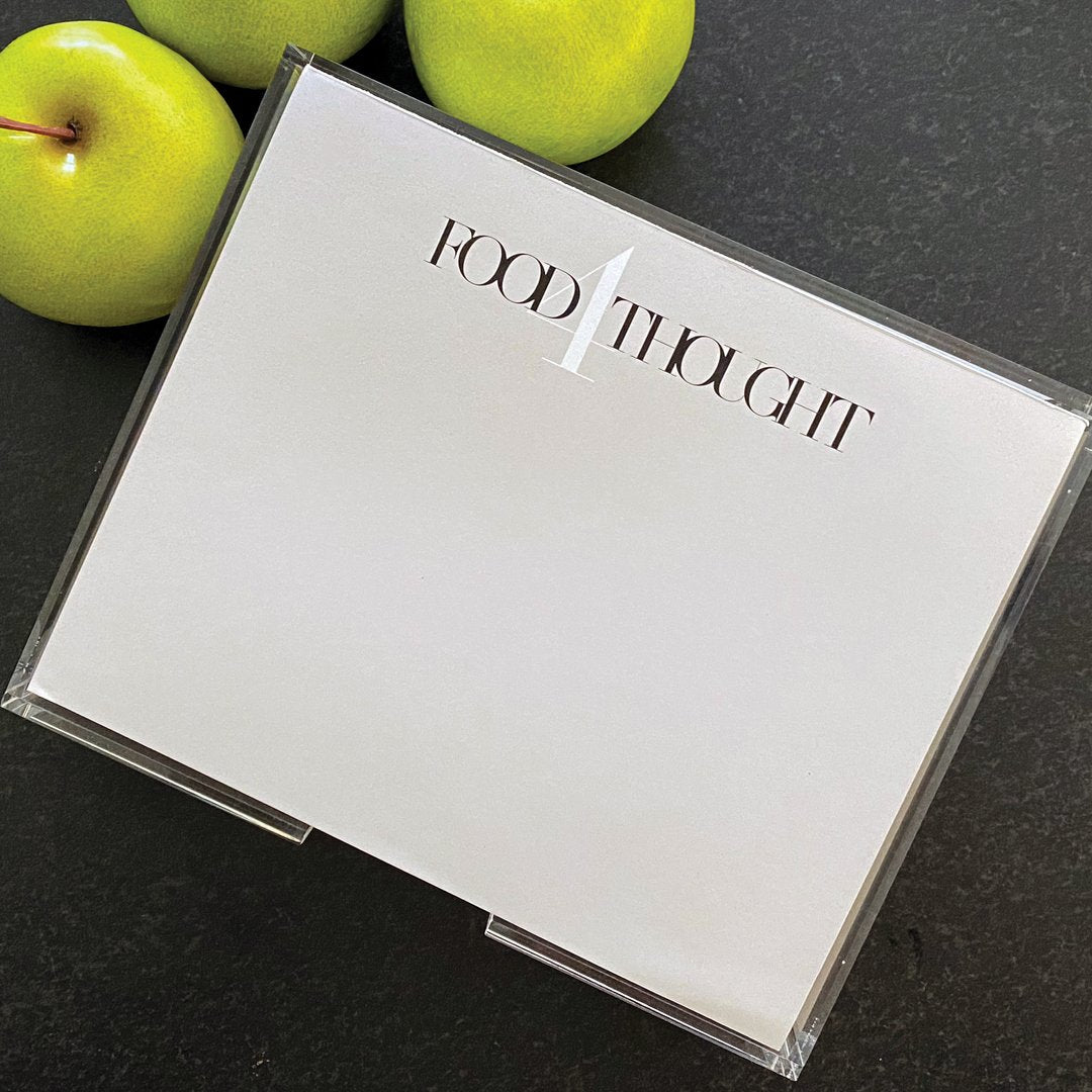 a photograph of the Food 4Thought note pad in a light grey paper