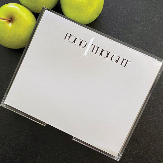 a photograph of the Food 4Thought note pad in a light grey paper