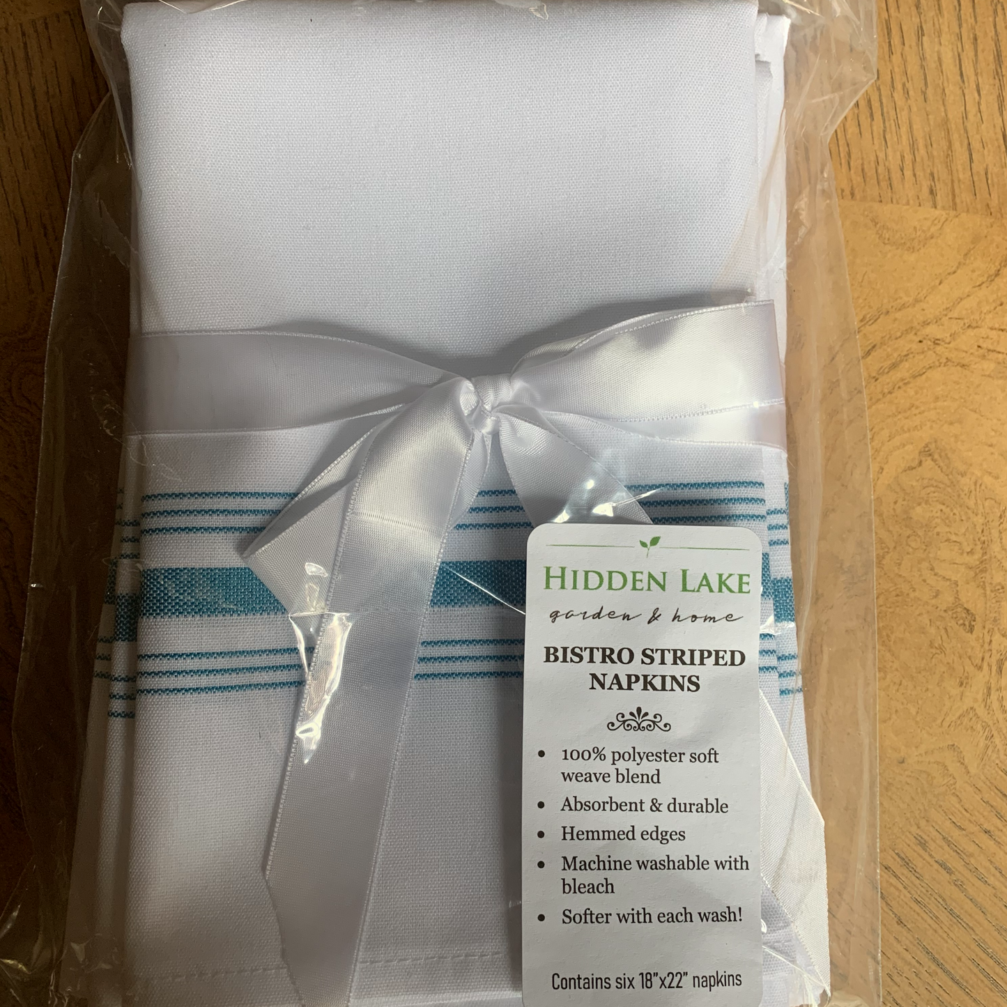 Bistro Striped Napkins in blue. Tied with a white satin bow.