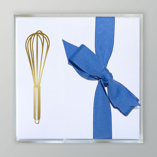 A photo of the Gold Embossed Kitchen Whisk  on  5 x 5 stationery paper tied with a blue ribbon