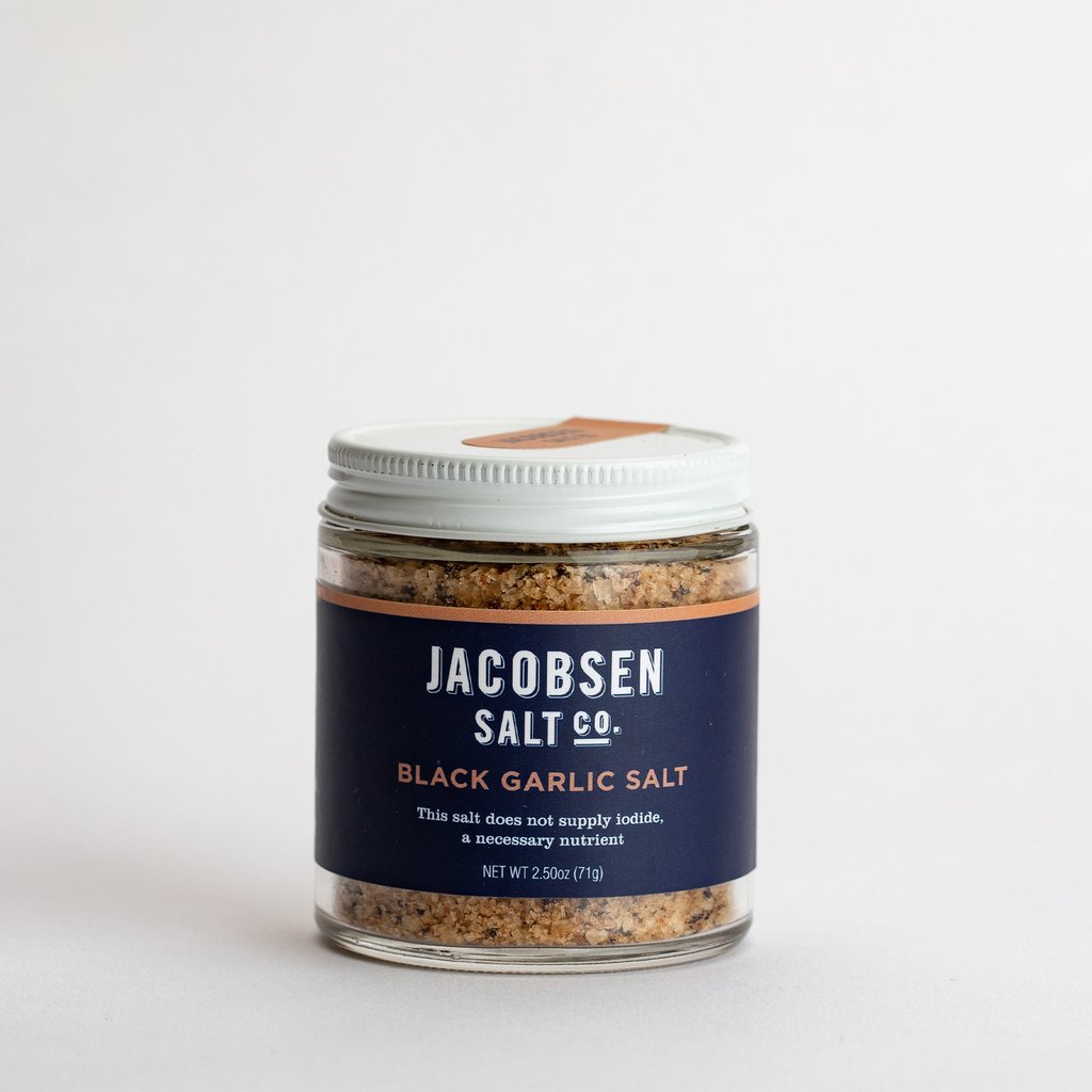 A picture of the Jacobsen Salt Companies Black Garlic Salt in a 2.5 oz glass jar.