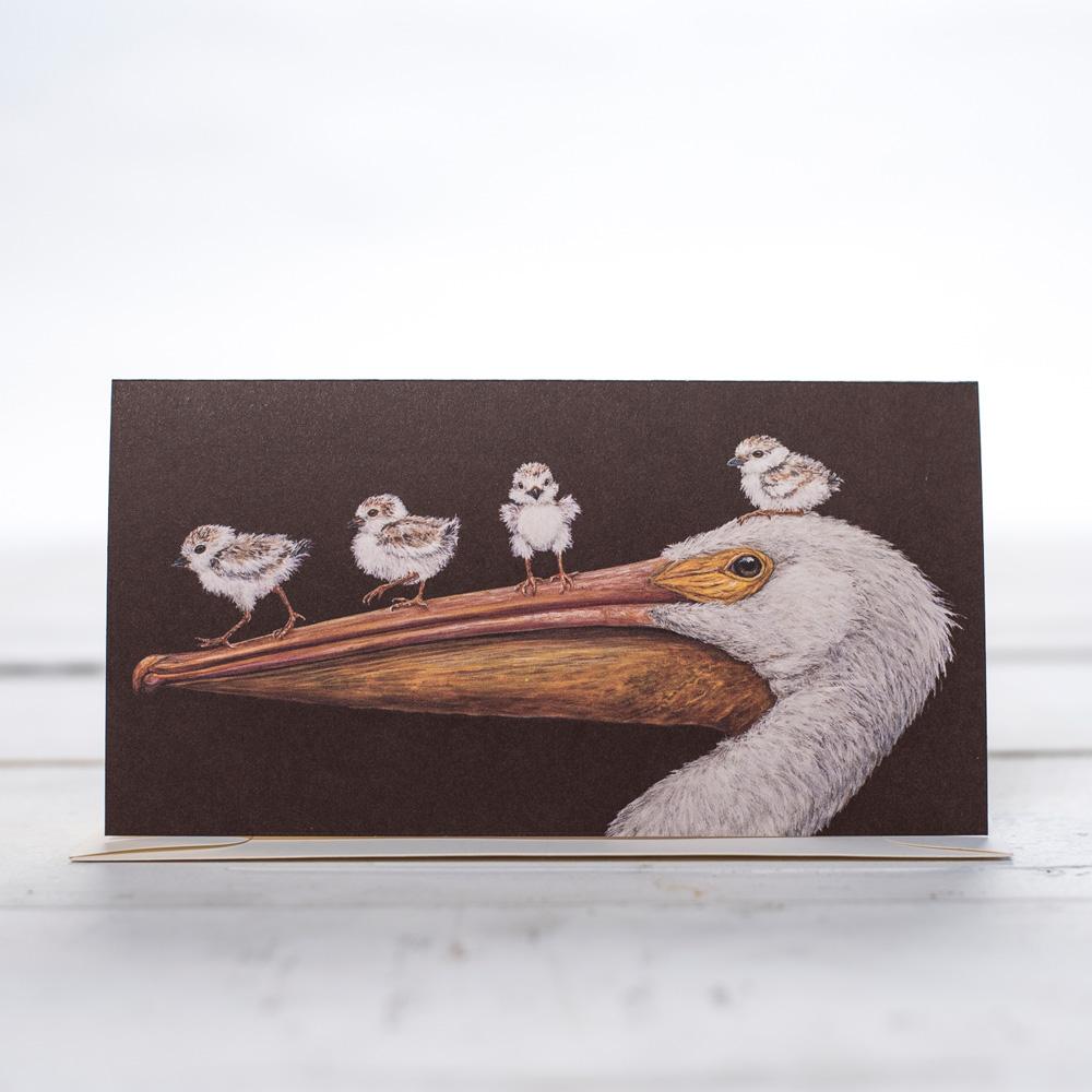 A large pelican with four baby pelicans walking on his beak