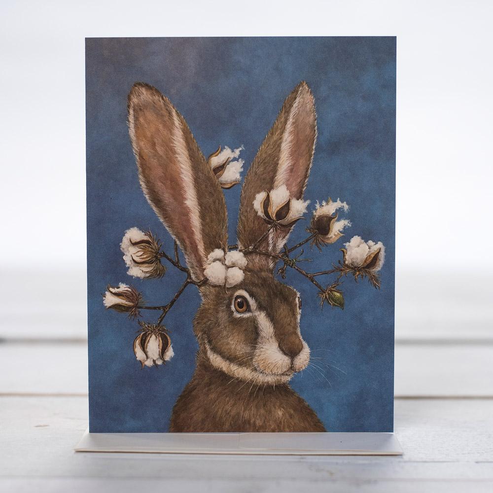 A rabbit with cotton branches draped on her ears.