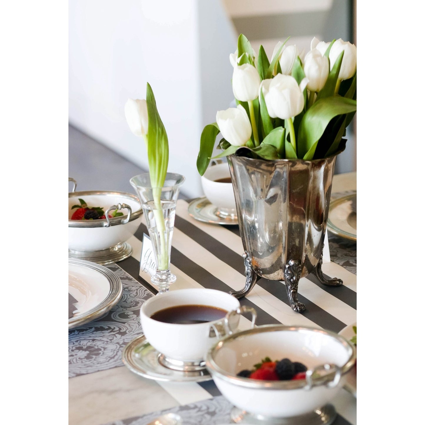 A photograph showing the Tapestry Placemat in a more formal table sitting with the use of silver rimmed dinnerware