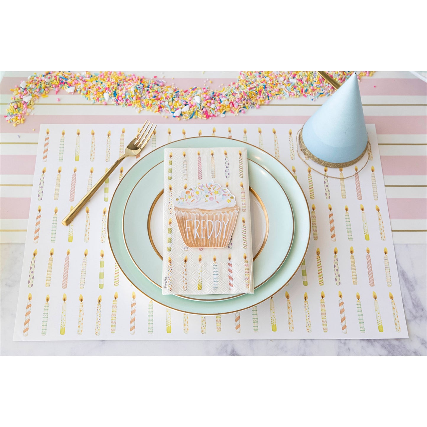 a overhead look at the birthday candle placemat setting using the cupcake place card with the persons name written on it.