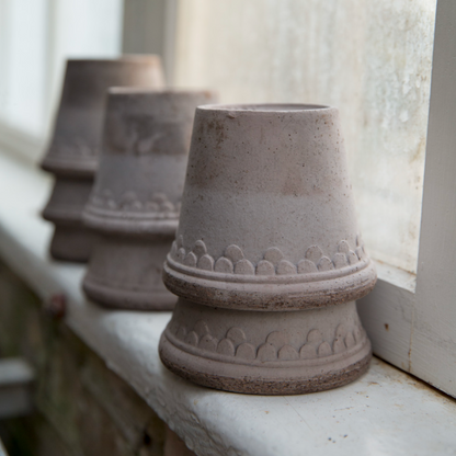 Six Copenhagen Pots lined up on a window ledge in Grey.