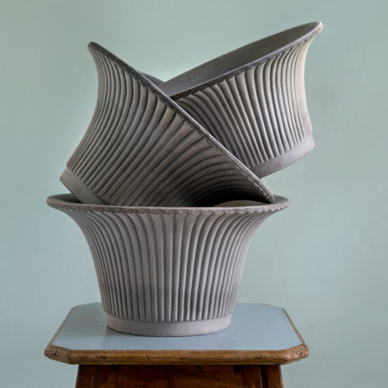 A stack of 3 grey colored Daisy Planters