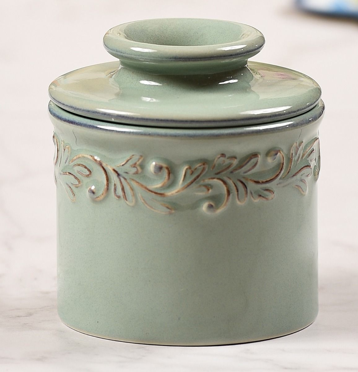 Antique Sea Spray Butter Bell with intricate embossing all around the top, resembles the leaves and crawling vines of a french vineyard.