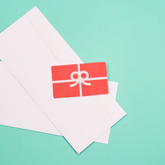 A picture of a bright red gift card laying on white envelops.
