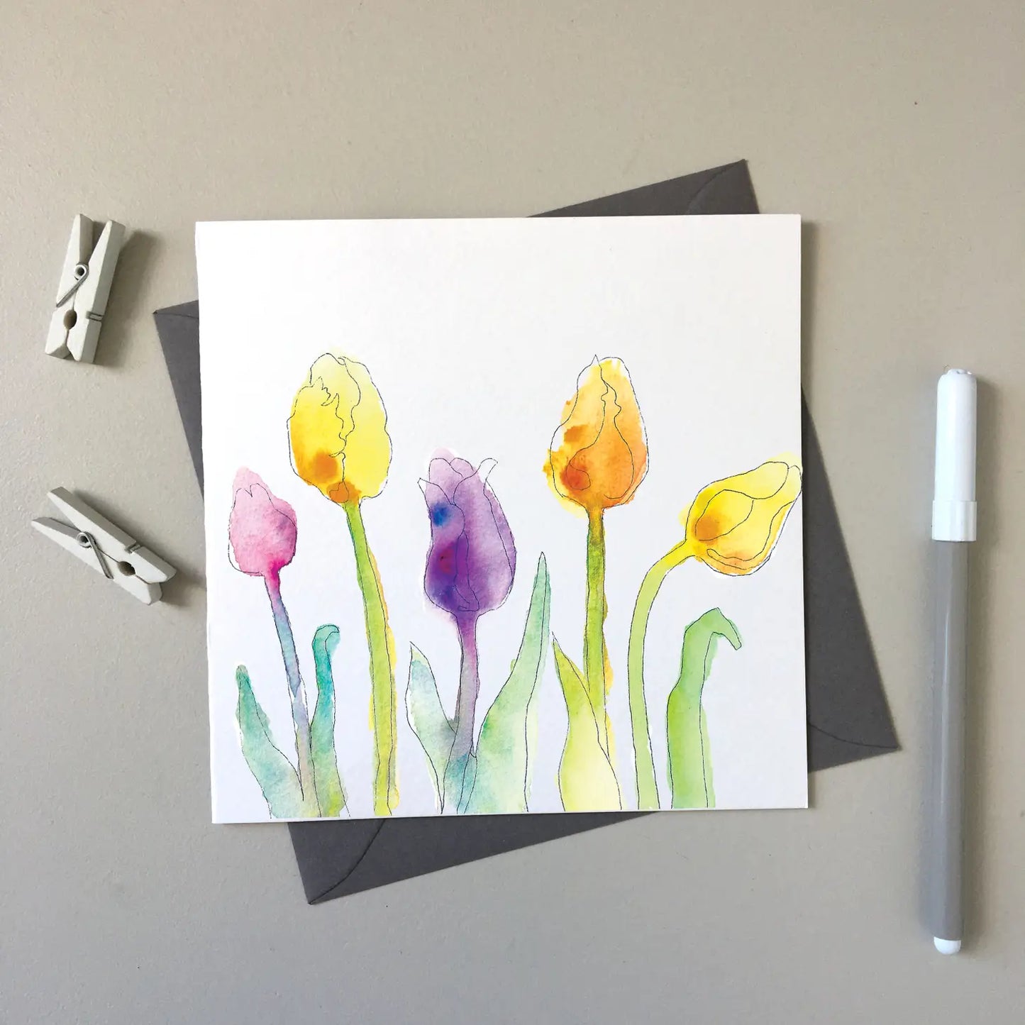 Beautiful watercolored tulips in yellow, purple and pink.
