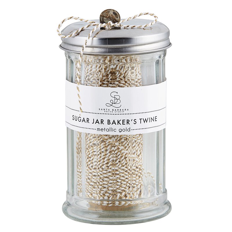 Metallic gold bakers's twine stored in a old fashion sugar jar.