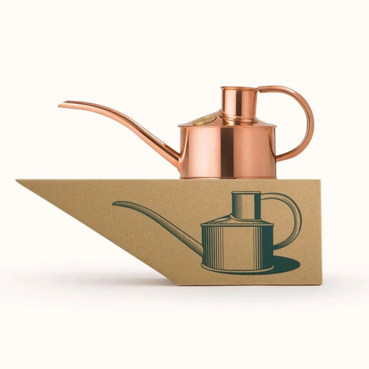 The Fazeley Flow Copper watering can setting on top of a special crafter box.