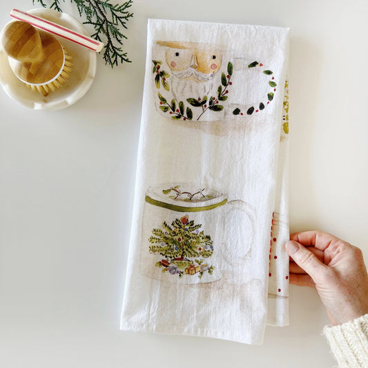 Emily Lex Christmas Mug Tea Towel featuring watercolor mugs of cocoa and candy canes folded.