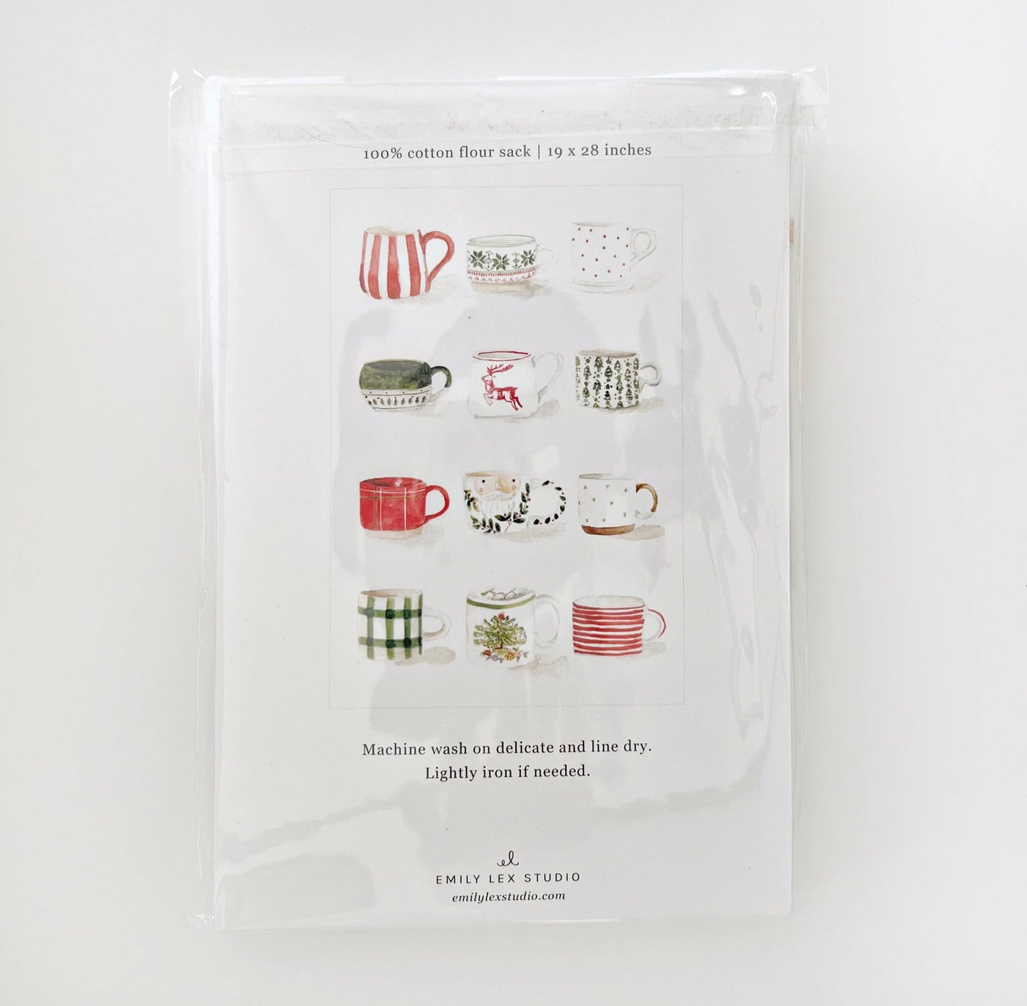 Emily Lex Christmas Mug Tea Towel featuring watercolor mugs of cocoa and candy canes, showing the back of the package