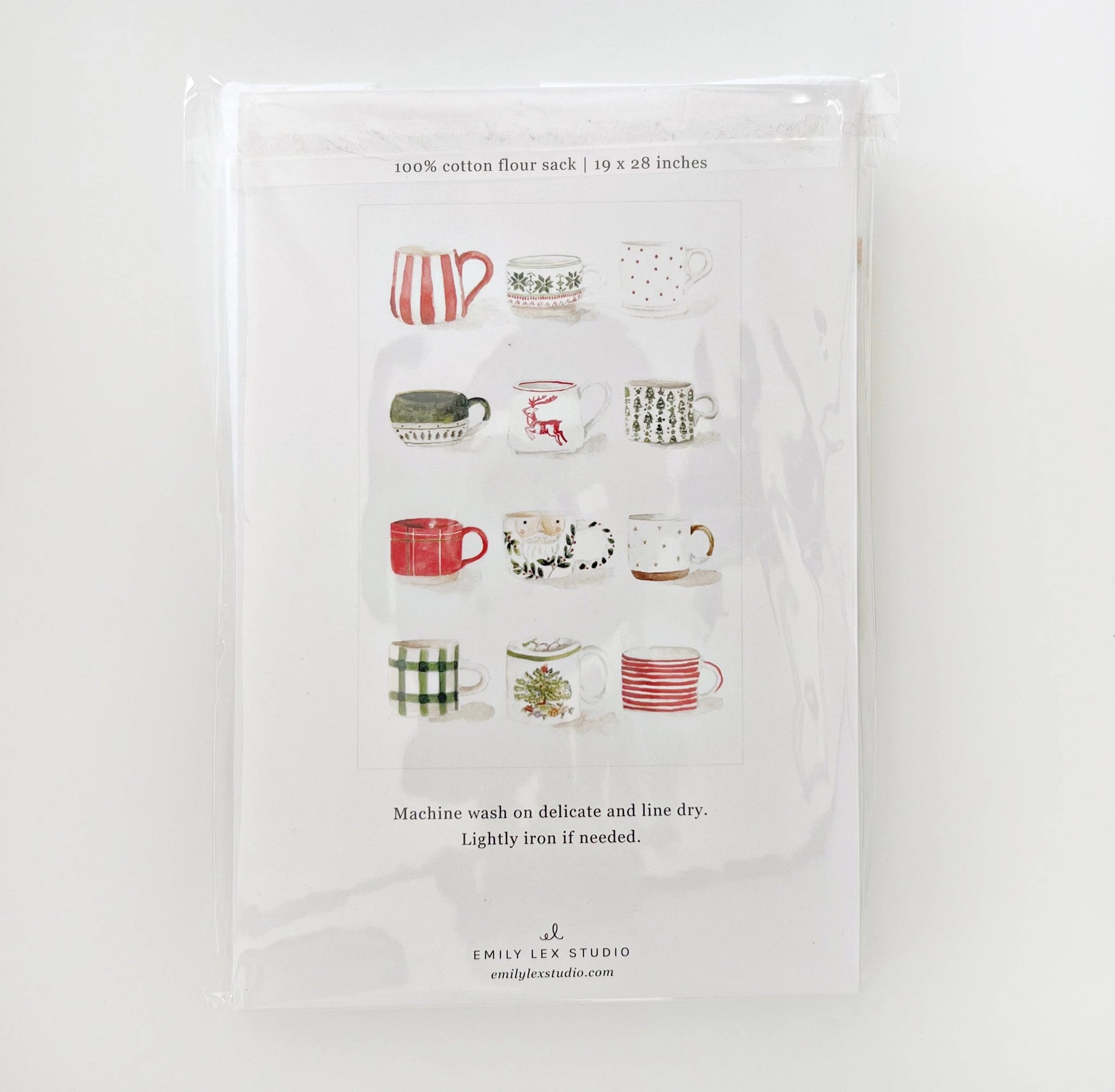 Emily Lex Christmas Mug Tea Towel featuring watercolor mugs of cocoa and candy canes, showing the back of the package