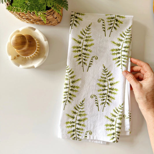Alt Text: Emily Lex Fern Tea Towel folded with delicate watercolor green fern leaves.