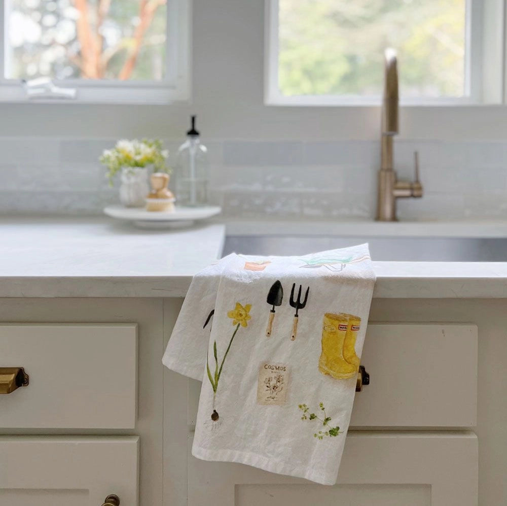 Emily Lex Gardening Tea Towel draped over the counter by the sink.