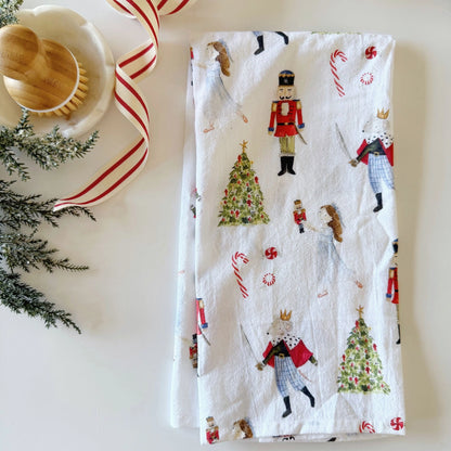 Emily Lex Nutcracker Tea Towel featuring watercolor nutcracker soldiers on a white background.