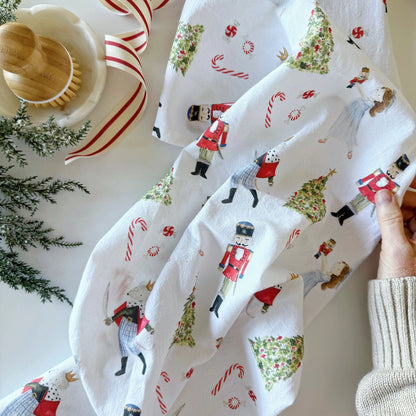 Emily Lex Nutcracker Tea Towel featuring watercolor nutcracker soldiers on a white background, full view.