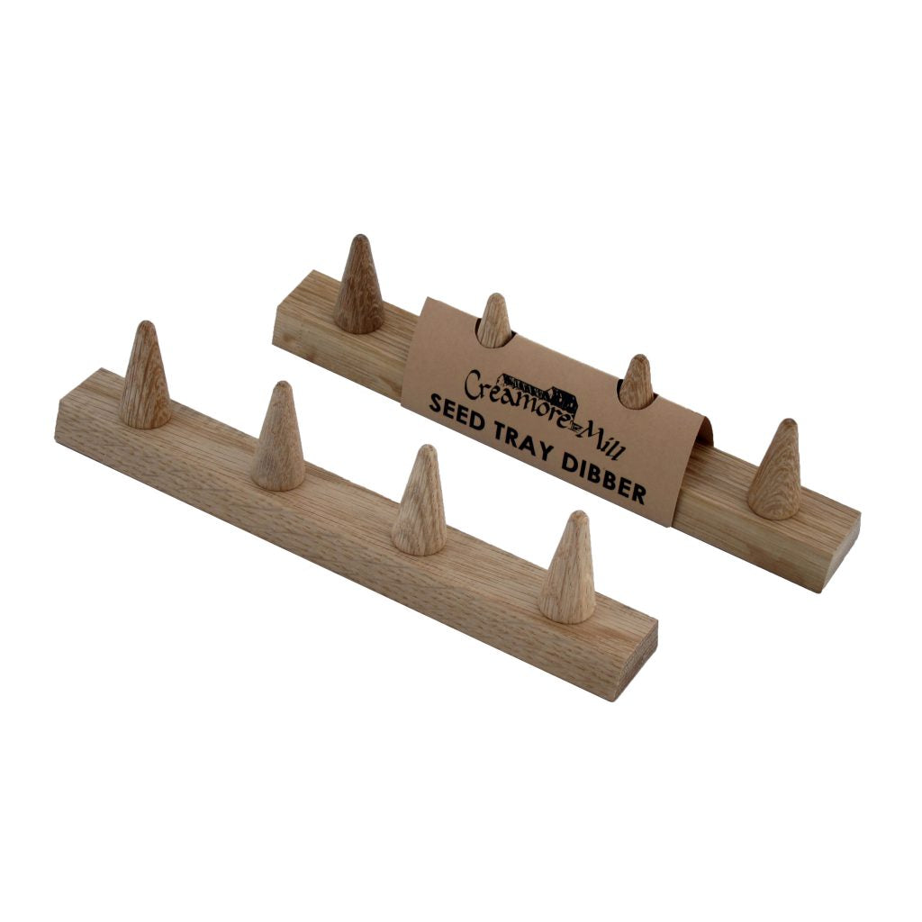 Two Creamore Mill Seed Tray Dibbers in natural oak shown from different angles on a white background