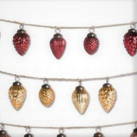 Red and gold mercury glass christmas ornaments strung on a string 