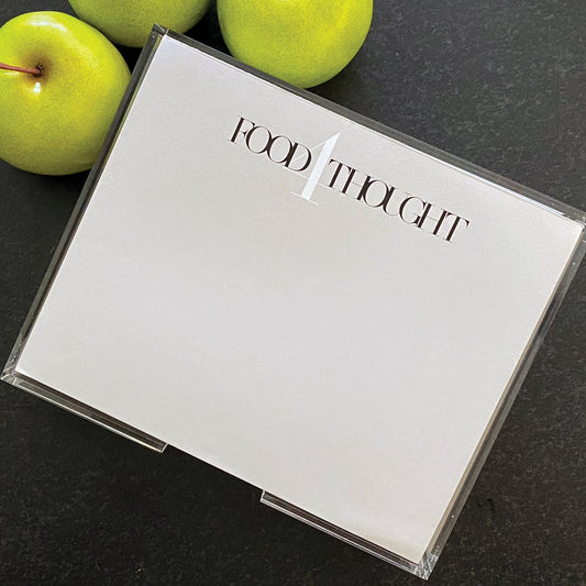 a photograph of the Food 4Thought note pad in a light grey paper 