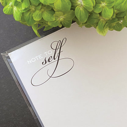 A close up of the title "Note to Self" notepad in light grey paper.