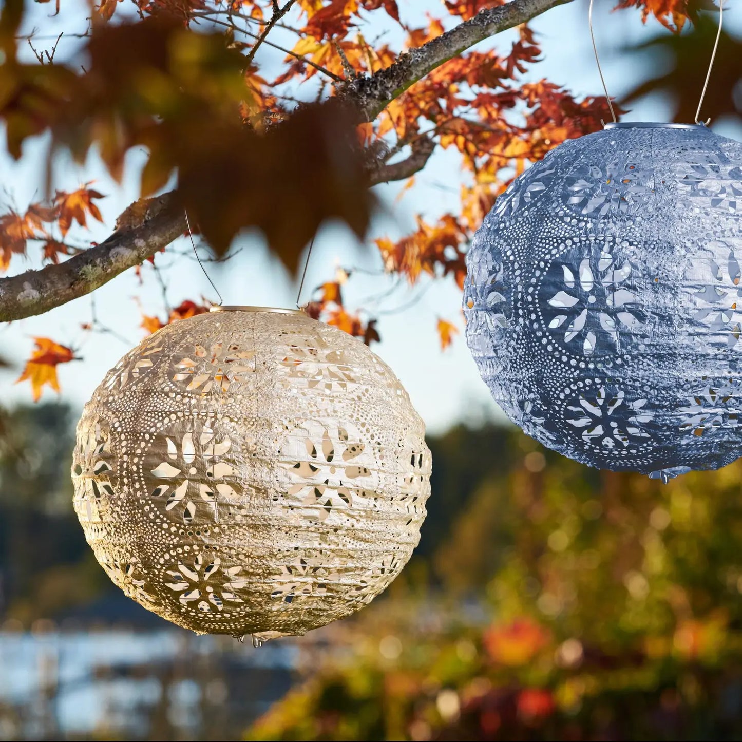 Image showing two of the solar hanging lanterns in the Stella Boho  Globe Collection.