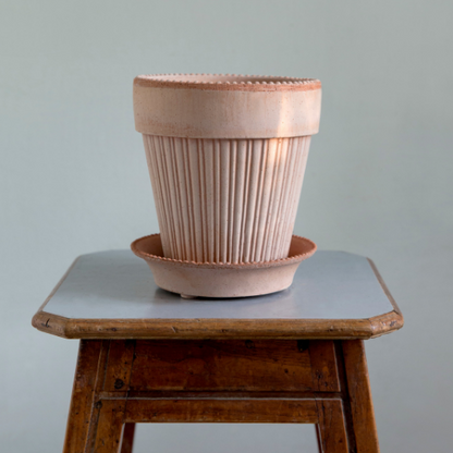 A close up shot of the Simona pot and saucer. It is shown in the Rosa color.