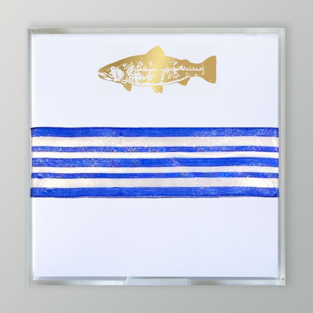 A picture of the Gold Printed Fish Pad in an acrylic tray tired with a blue and white striped ribbon.