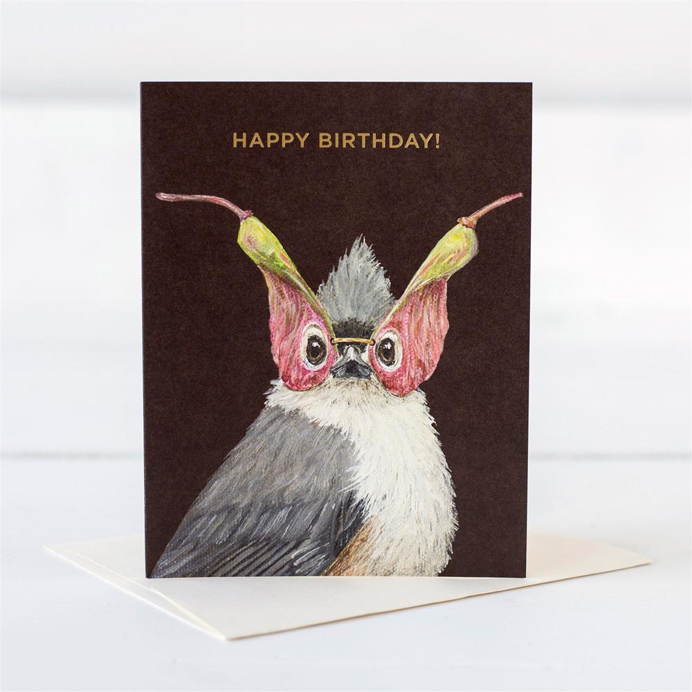 A Titmouse wearing a mask made from seed pods wishing someone a happy birthday
