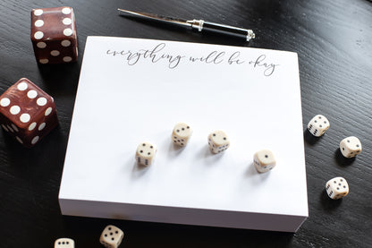 a picture of the note pad with playing dice all around the note pad.