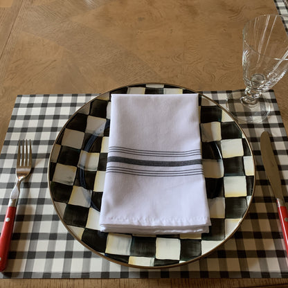 Showing the black checked placemat with red flatware and a bistro striped napkin.