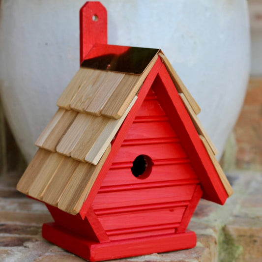 The Chick bird house in neon red. So cute with it red color and natural roof.