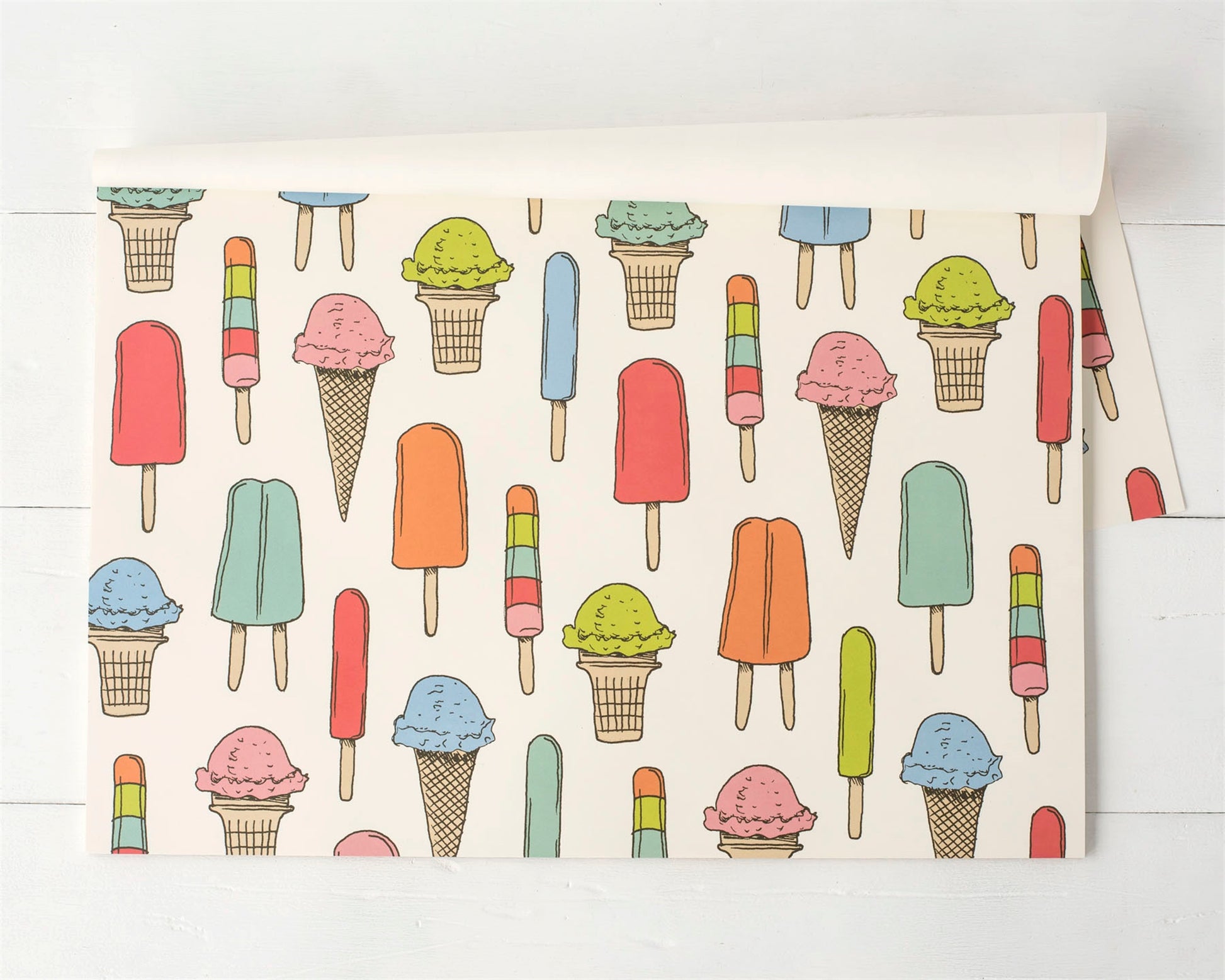 A paper placemat designed with all kinds of popsicles and ice-cream cone. Great for a birthday party.s