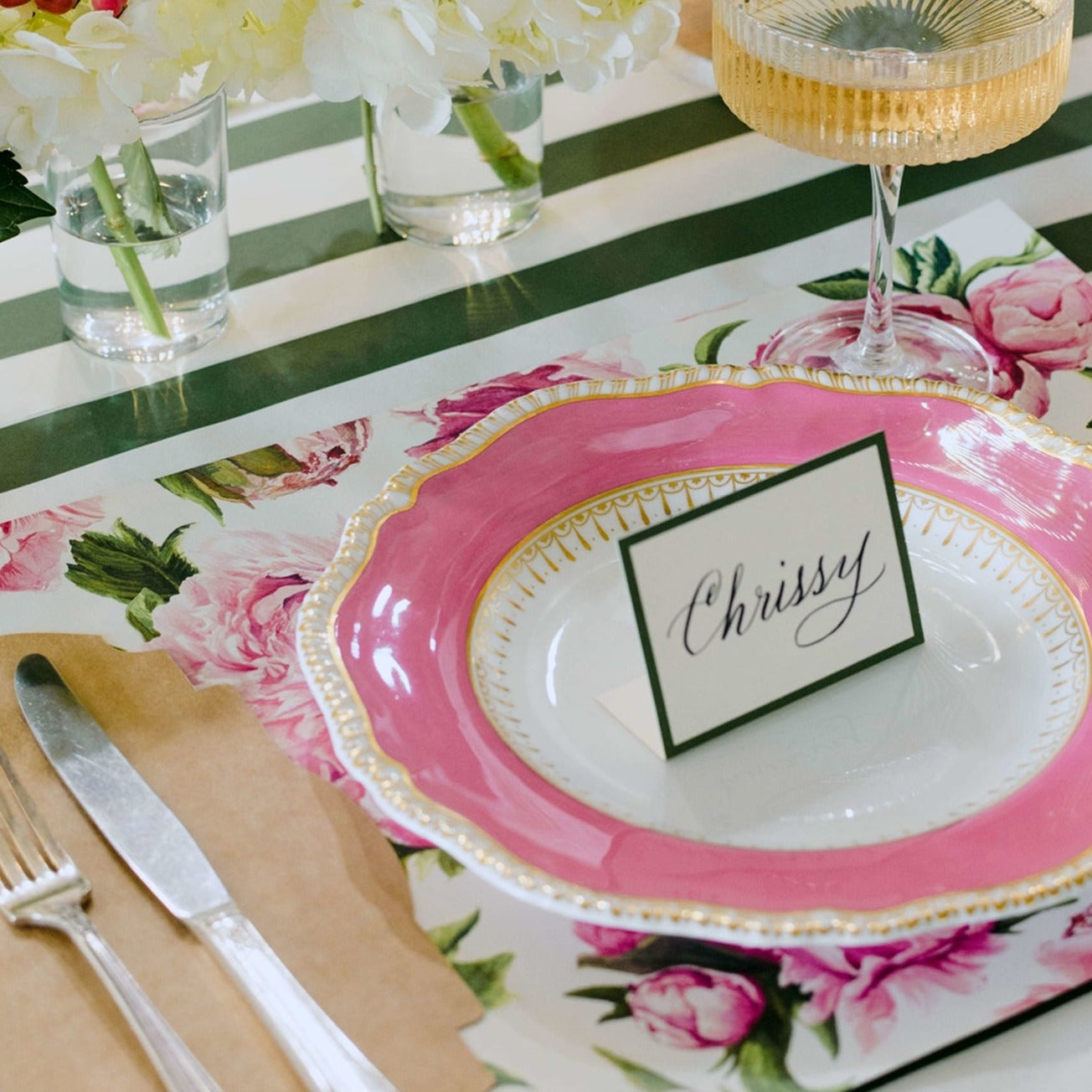 Showing a table setting using the Peonies in bloom placemat and green boarder place card.