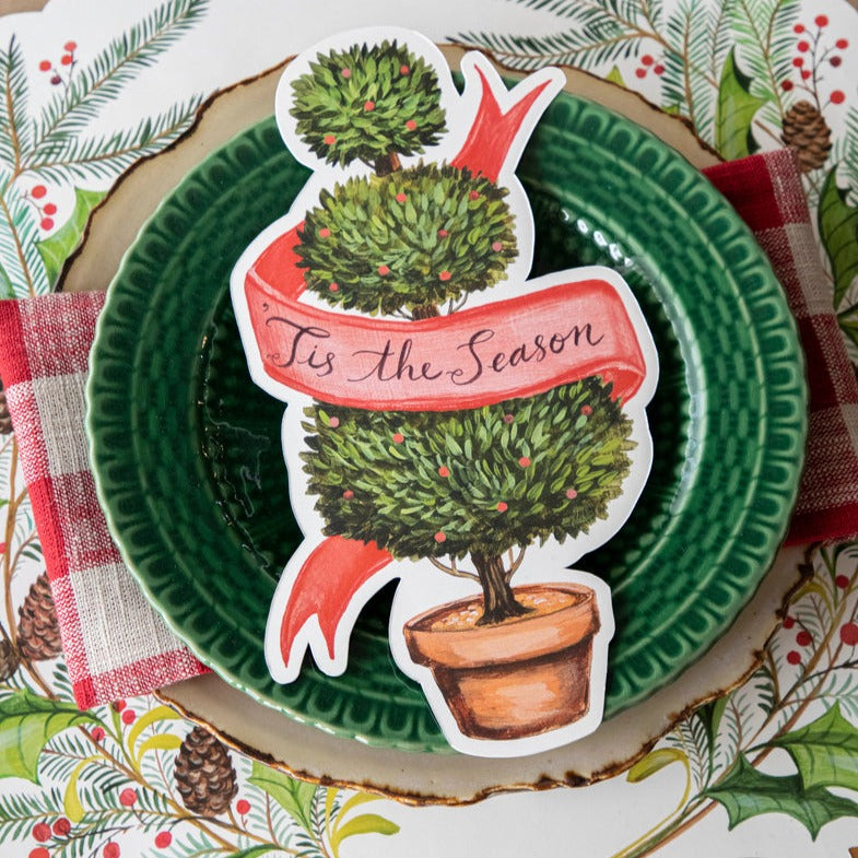 Christmas Sprigs paper placemat shown set with place-card and green dish.