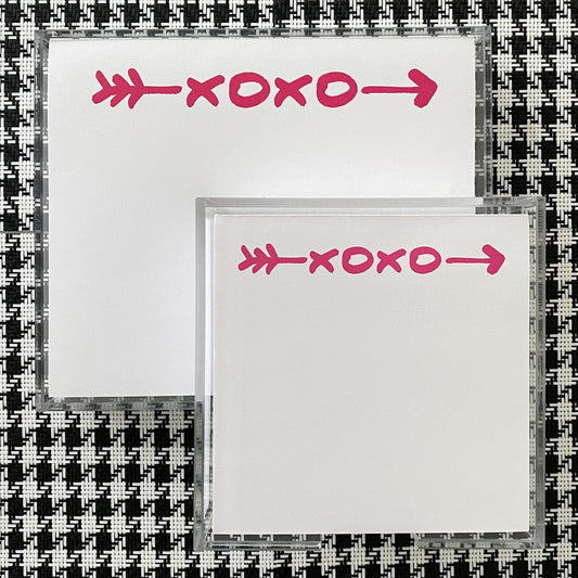 A photo showing the hugs and kiss small paddie and the large pad.  The x and o's are in bright pink , very cheerful.