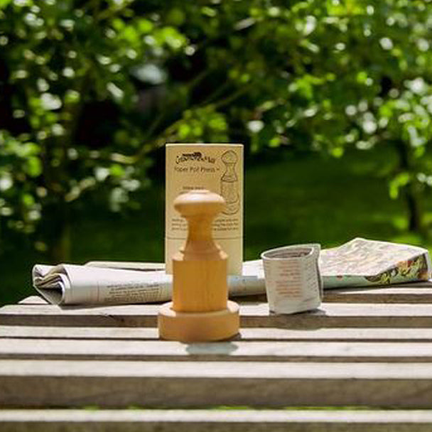 Showing the press and a paper seed pot that it has created.