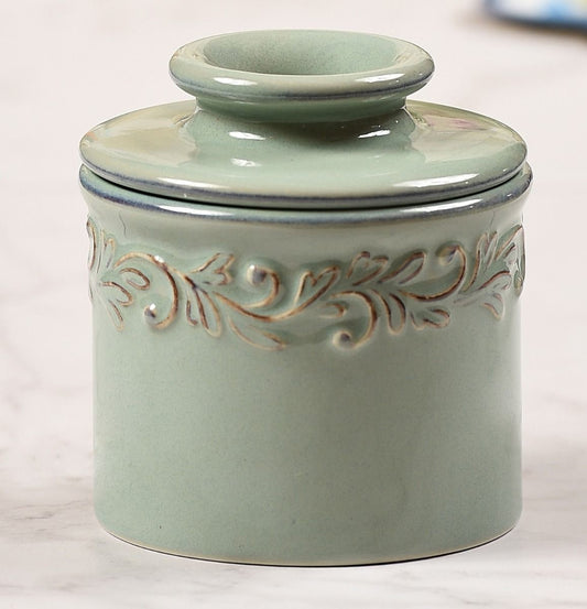 Antique Sea Spray Butter Bell with intricate embossing all around the top, resembles the leaves and crawling vines of a french vineyard.