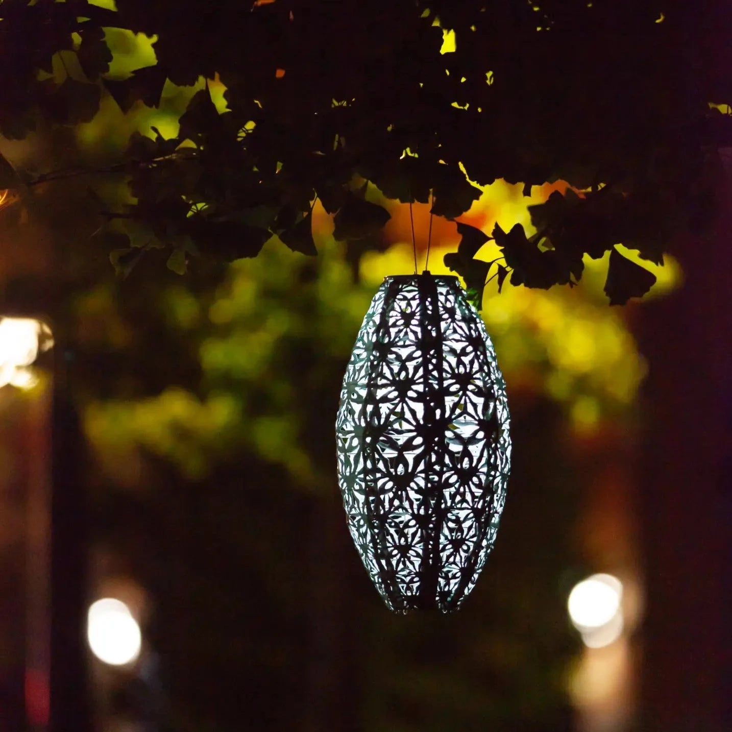 Night time image of the Solar Stella 15 Inch  Wildflower Pod Lantern.