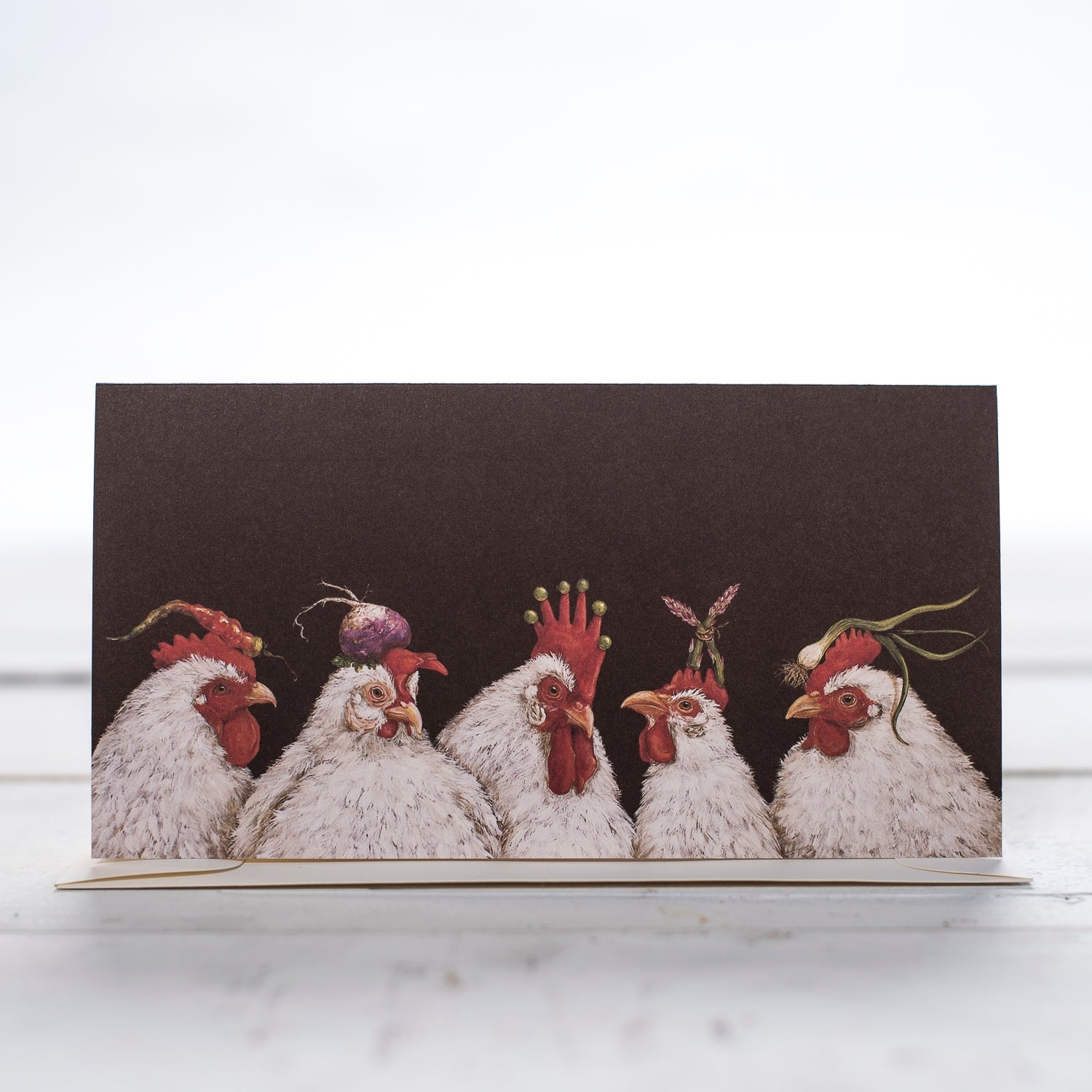Five white hens with red combs in a row.